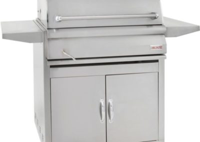 Stock photo of Blaze Charcoal grill with fold down tables and two doors for storage on the bottom.