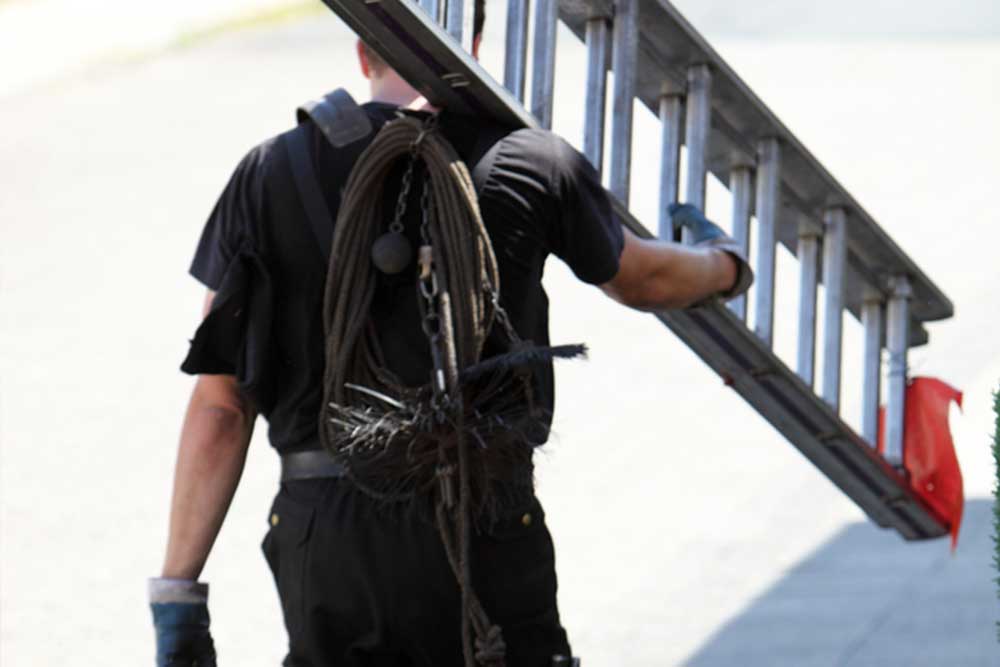 Man carrying ladder on his right shoulder