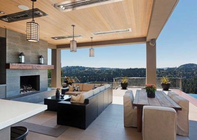 Stock photo of W Series2 outdoor fireplace and kitchen with a table and chairs, two sofa's and a great view of the mountains.