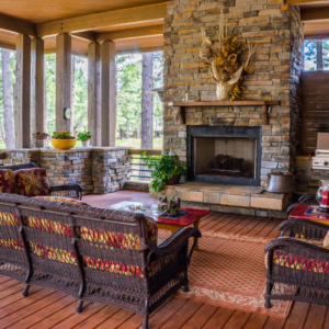 a rustic-looking living room with a stone fireplace