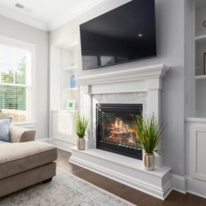 a gas fireplace in white-framed fireplace in a living room